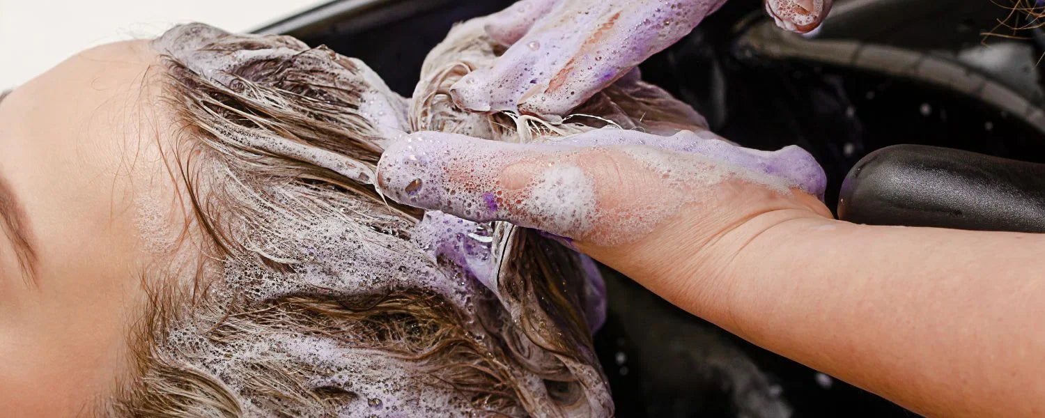 Kvinde får vasket hår med silver shampoo